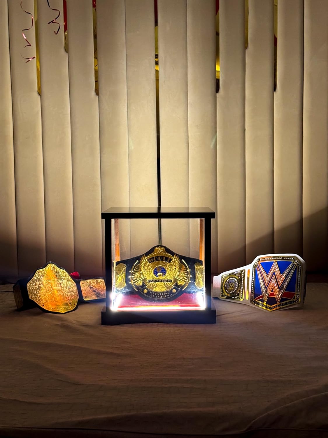LED championship belt display case with a WWF Winged Eagle belt glowing inside