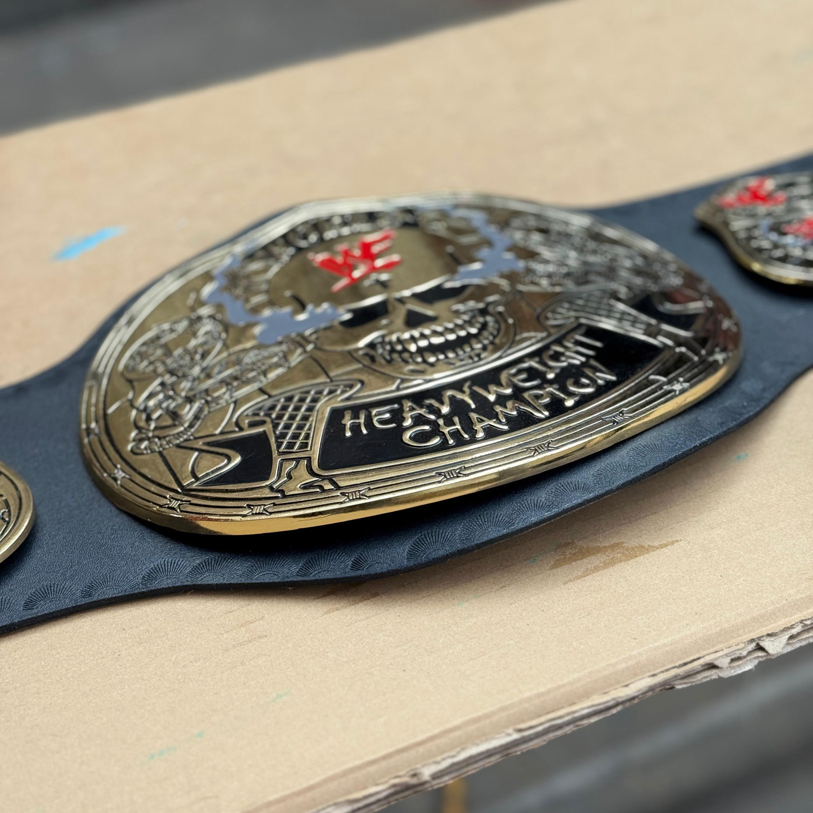 Casted championship belt plates during finishing in the Sialkot workshop
